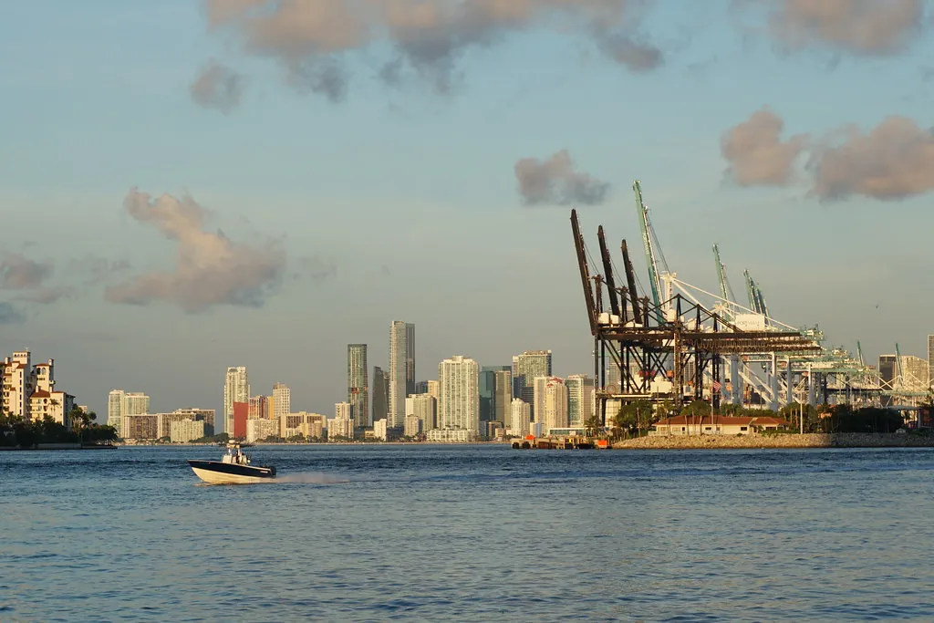 Cranes at the Port of Miami with the downtown skyline behind